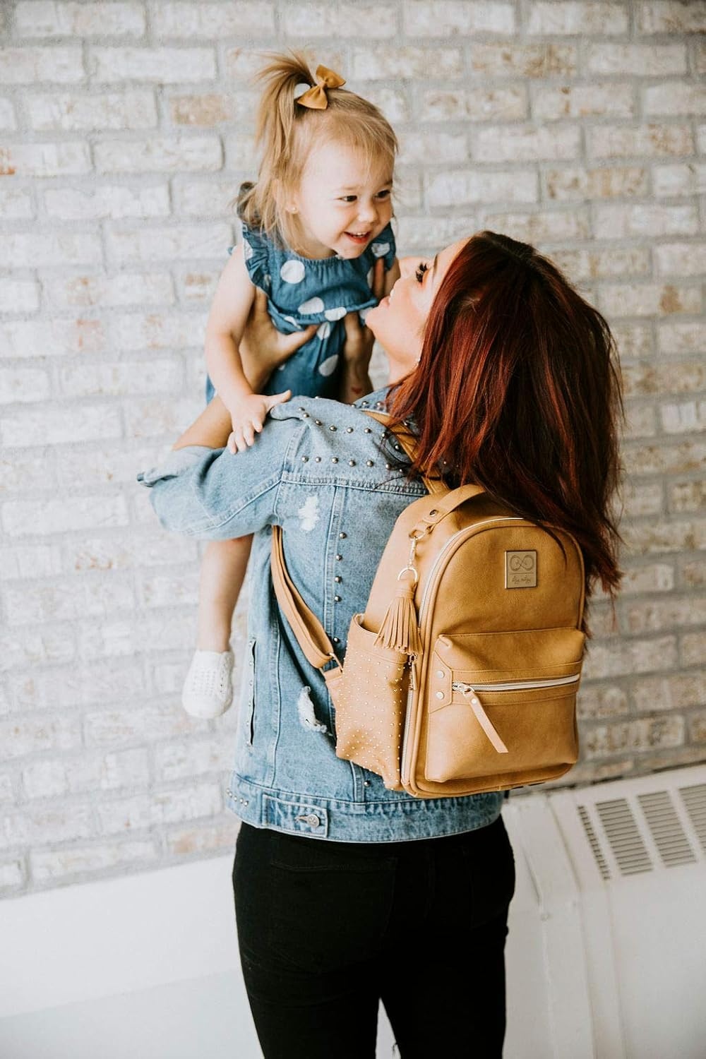 image:imageChelsea Cole for Itzy Ritzy Mini Diaper Bag Backpack Studded Mini Backpack with Changing Pad 8 Pockets Rubber Feet amp Tassel Caramel with Sweetheart Print Interior and Gold Hardware