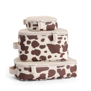 image:imageItzy Ritzy Packing Cubes For Travel  Set of 3 Packing Cubes or Travel Organizers  Each Cube Features a Mesh Top Double Zippers and a Fabric Handle Purple DinosaursCow Print